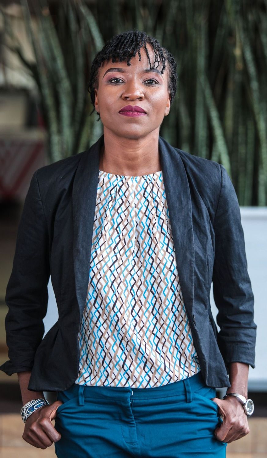 Diana Ayoo standing with her hands in her pockets