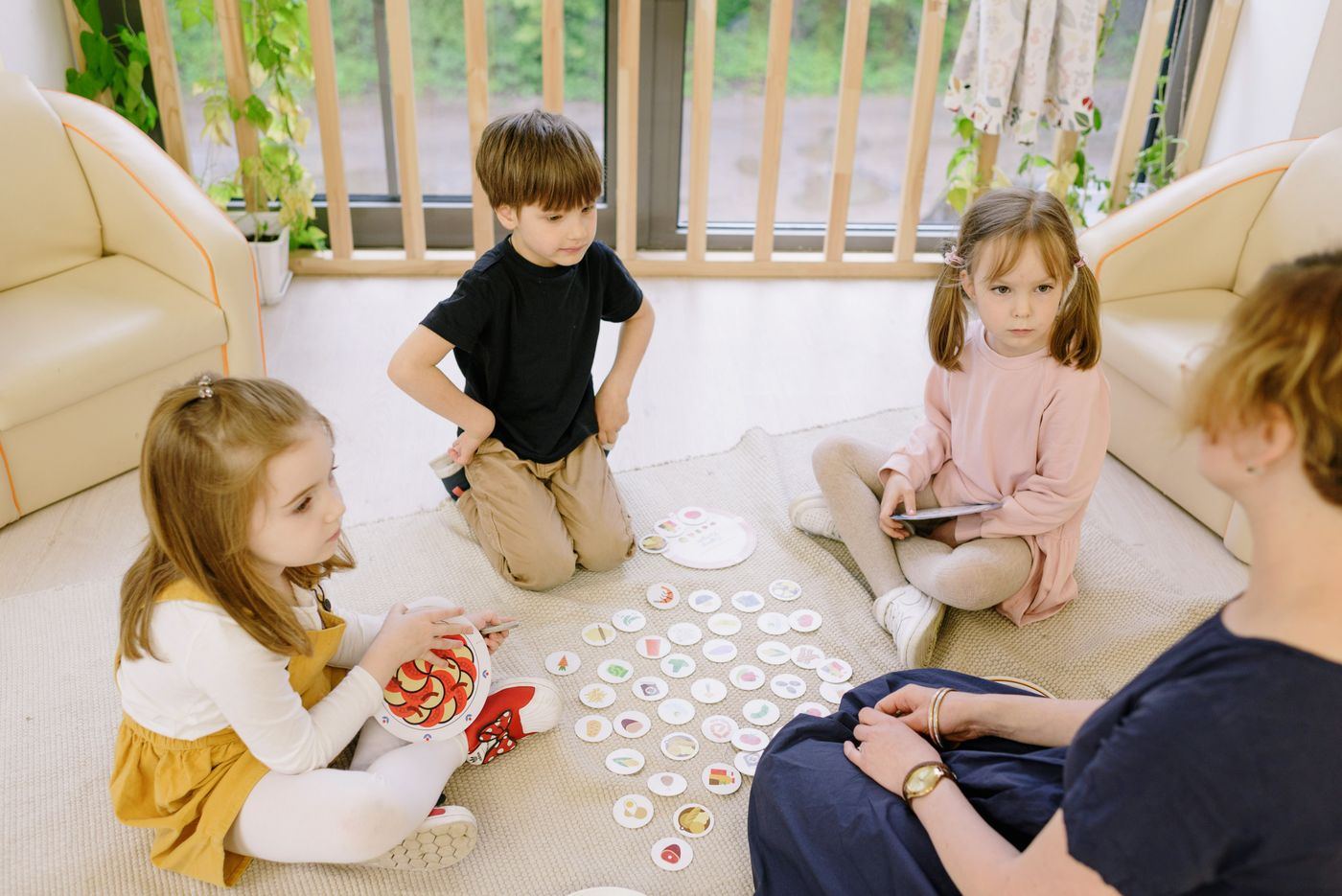 Children learning with a teacher at a low table